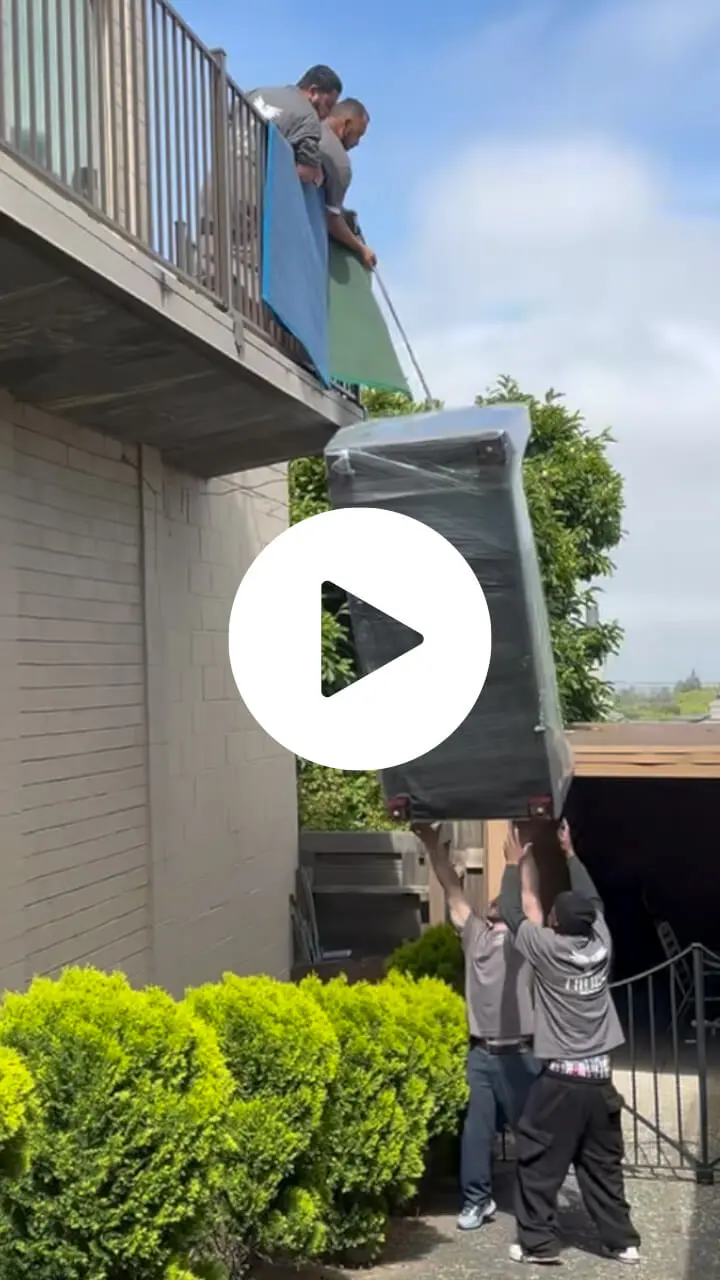 Moving team lowering a couch